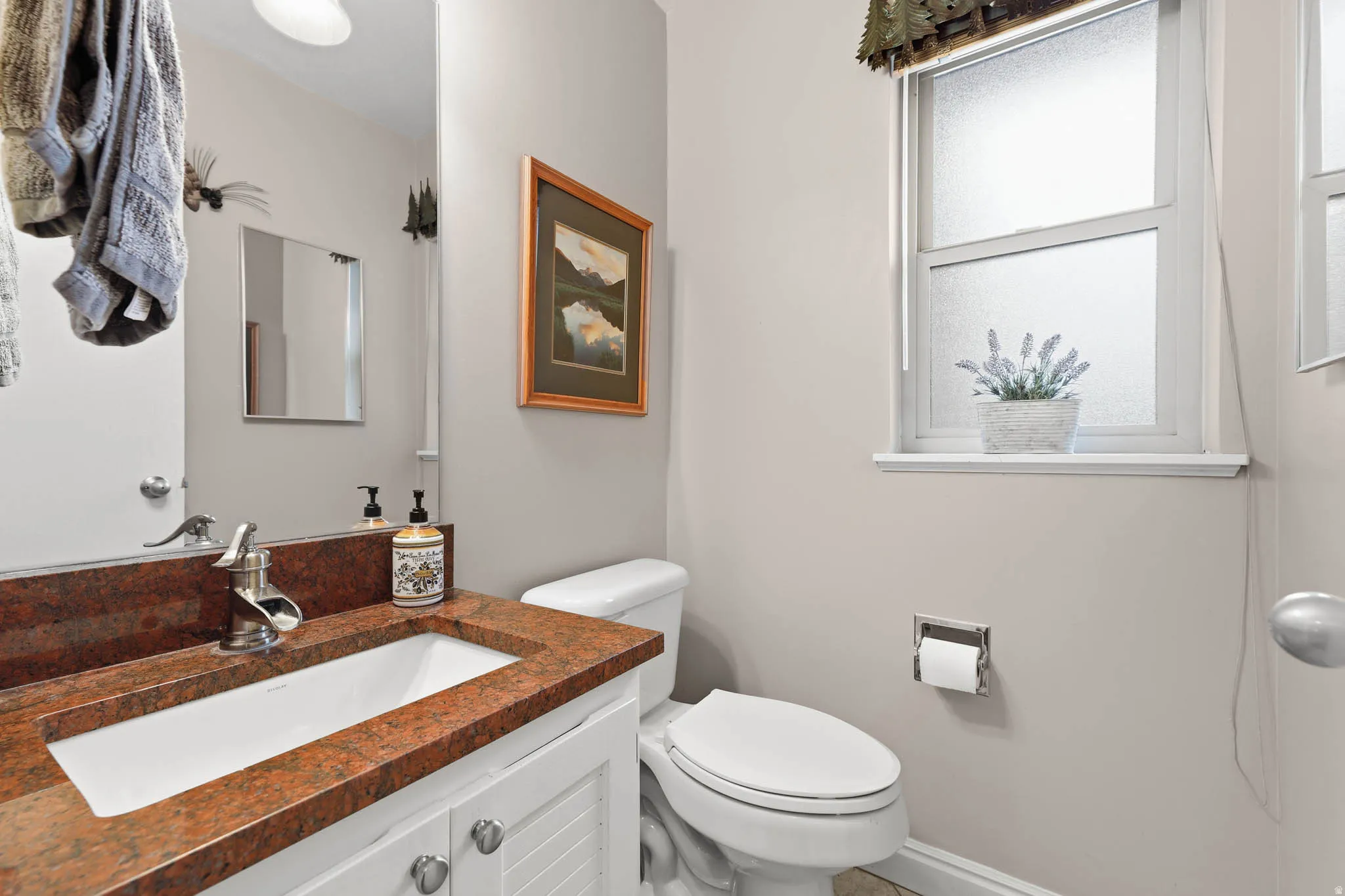 Half bath with vanity and toilet