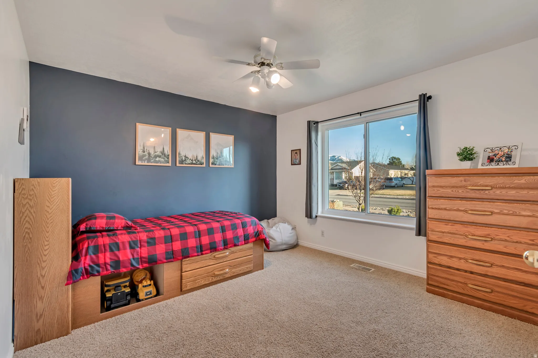 Carpeted bedroom featuring a ceiling fan and baseboards