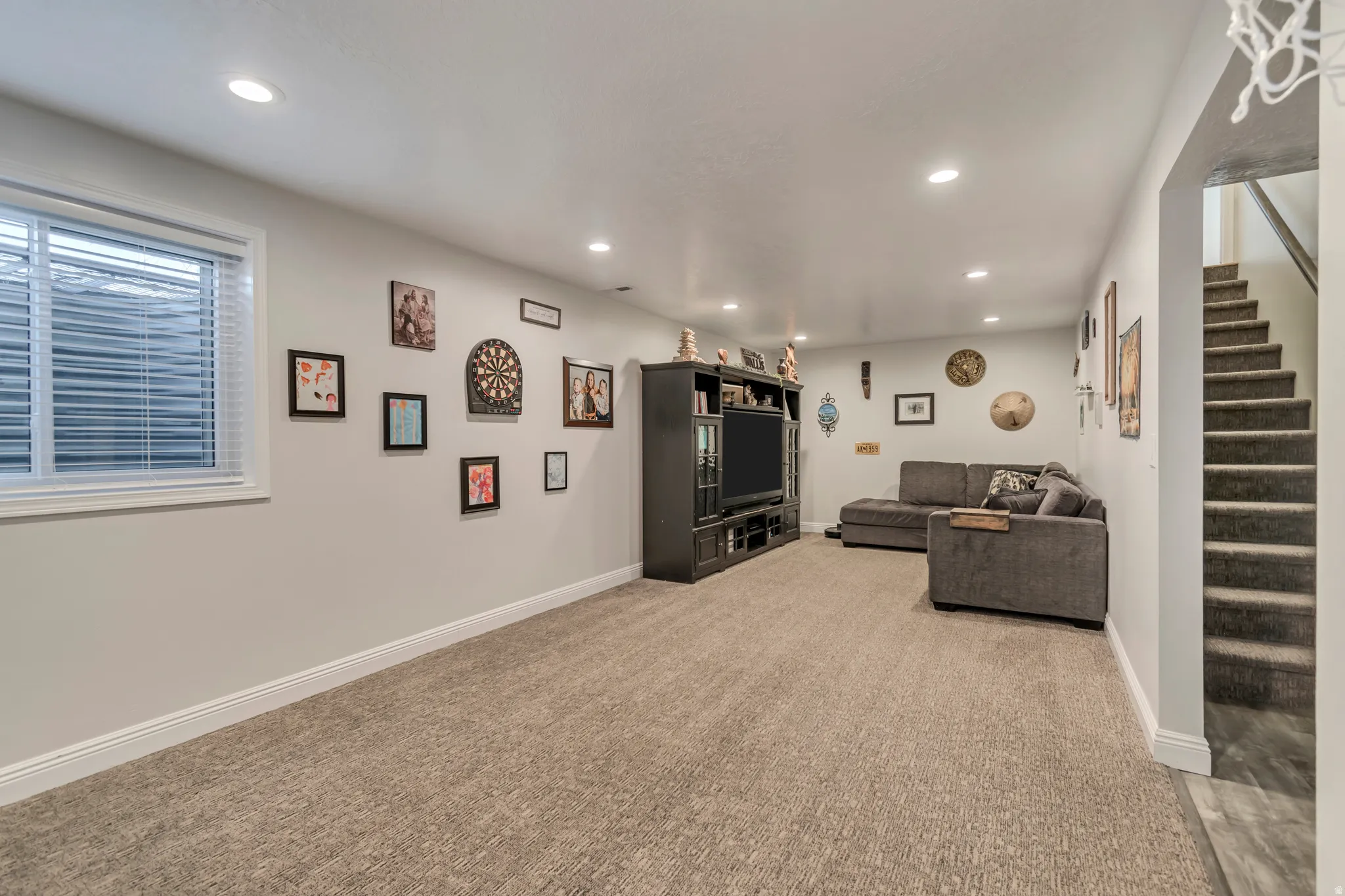 Living room with recessed lighting and light colored carpet