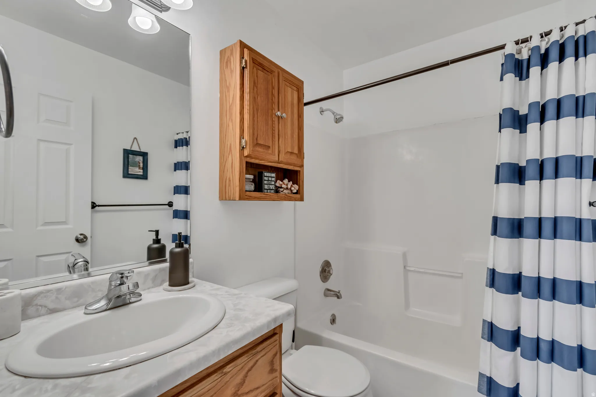 Full bathroom featuring vanity and shower / tub combo with curtain