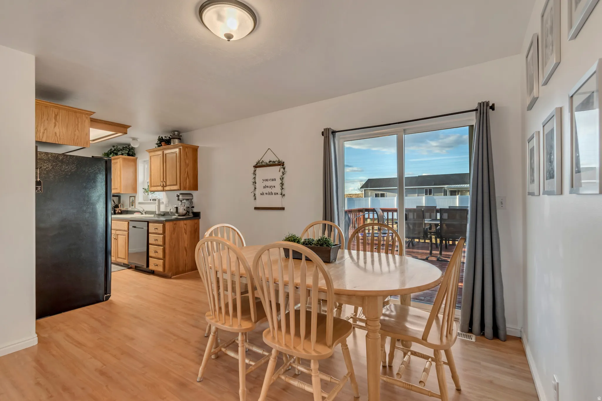 Dining area with light wood finished floors and baseboards