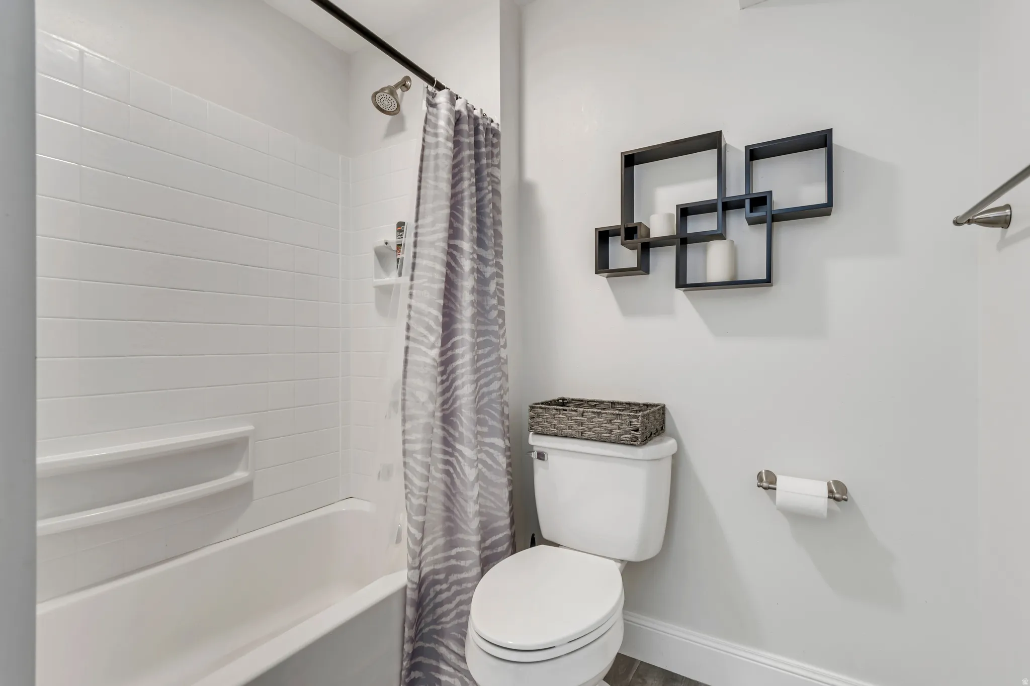 Full bathroom featuring toilet and shower / tub combo