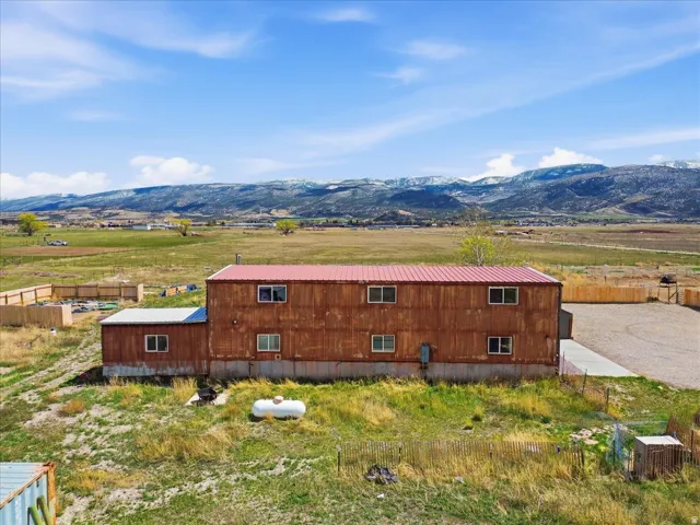 View of side of home featuring a rural view and a mountain view