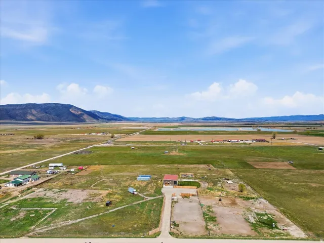Aerial view of sparsely populated area featuring a water and mountain view