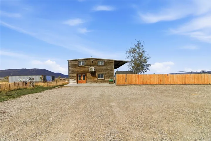 Rear view of house featuring a mountain view and a patio