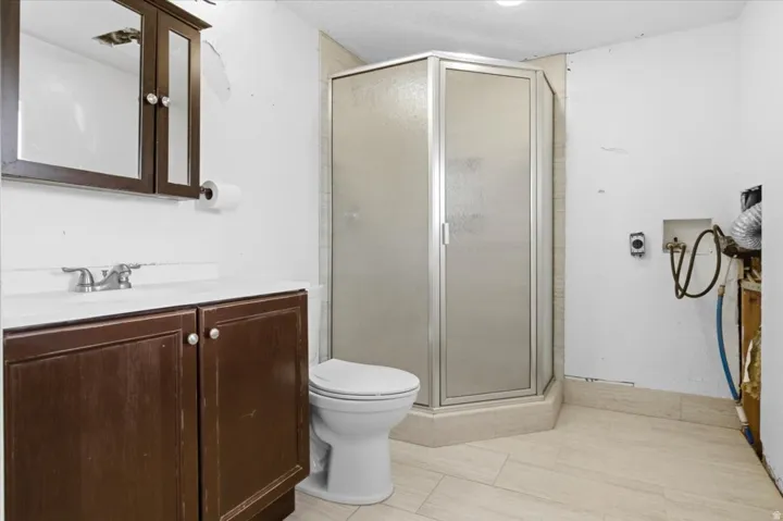 Full bath featuring vanity and a shower stall
