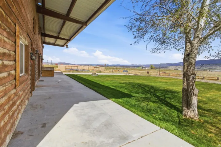 View of yard featuring a patio, a rural view, and a mountain view