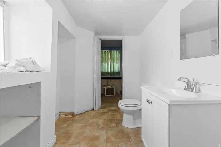 Bathroom with vanity and stone finish floors
