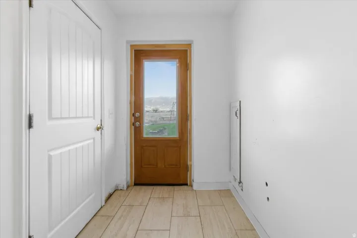 Entryway with baseboards and wood tiled floors