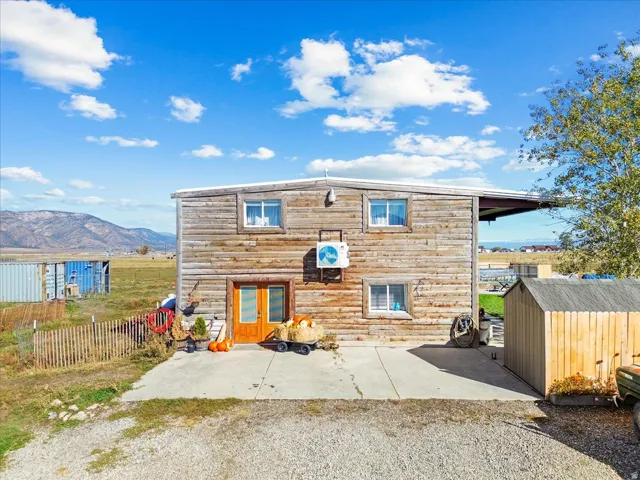 Rear view of house featuring a shed, a mountain view, a patio area, and french doors