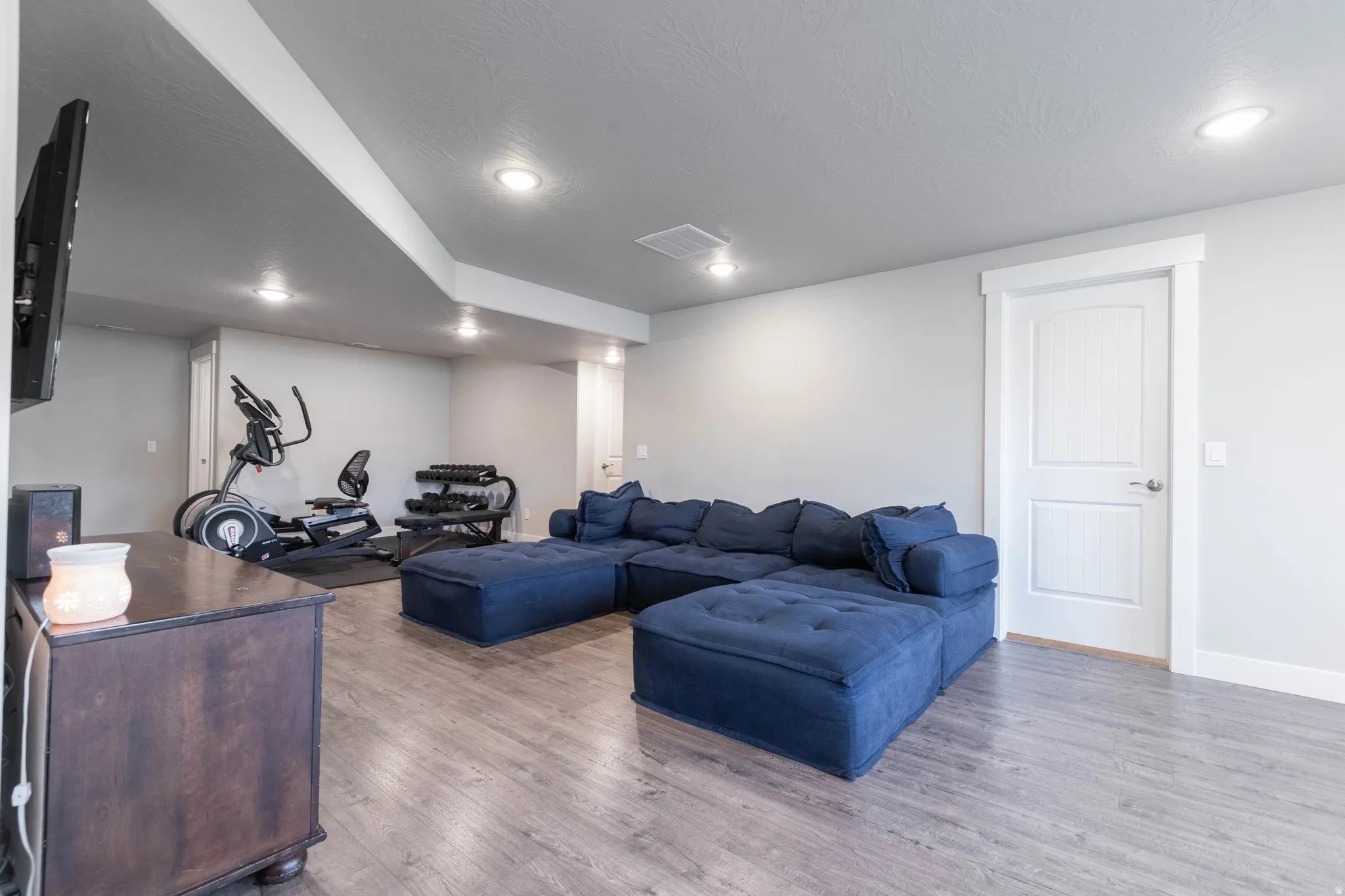 Living area featuring wood finished floors and recessed lighting