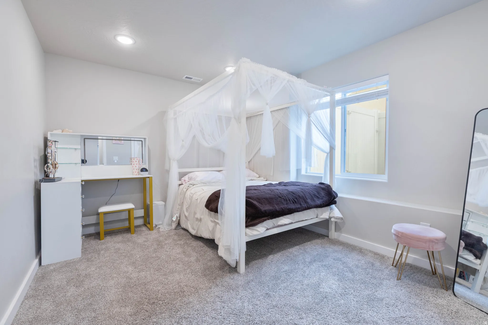 Bedroom with light carpet and recessed lighting