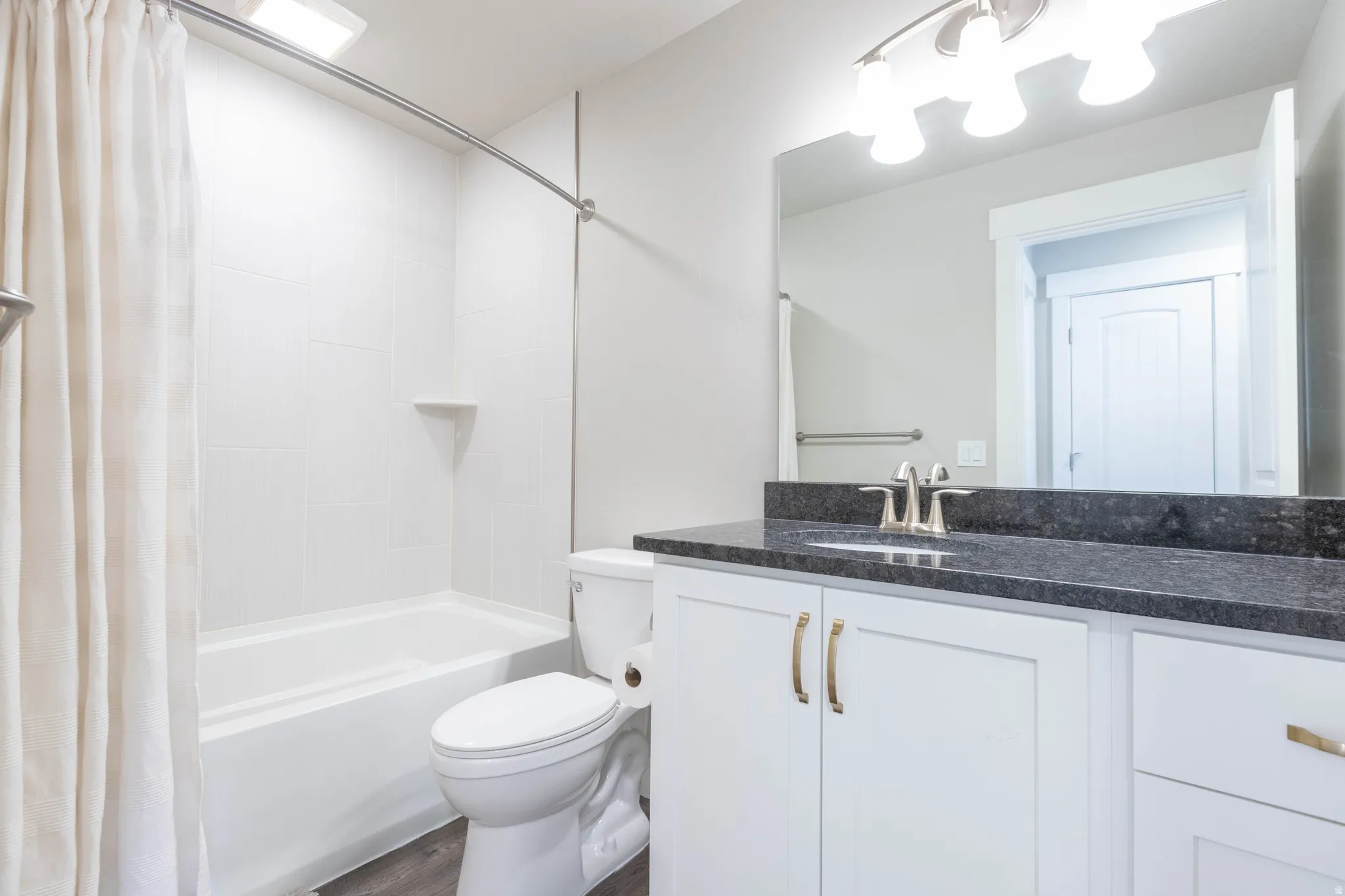Full bathroom with vanity and shower / bath combination with curtain