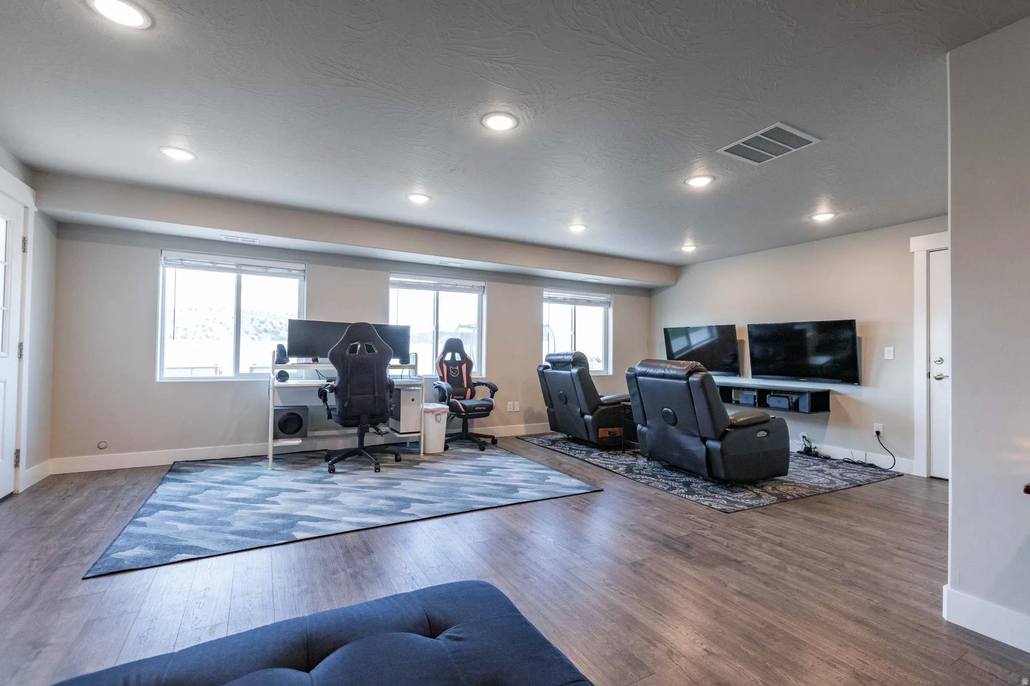 Office space with dark wood-style flooring and a textured ceiling