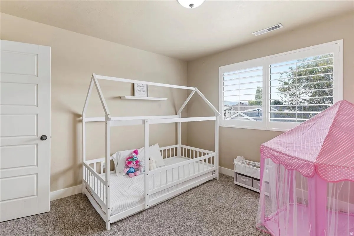 Carpeted bedroom with baseboards
