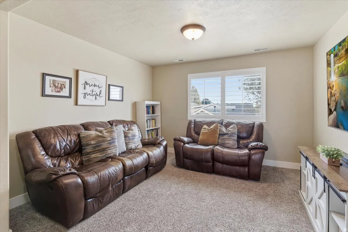 Living room with light carpet and baseboards