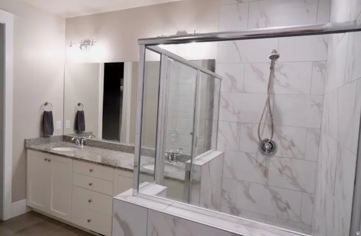 Bathroom with vanity and a stall shower