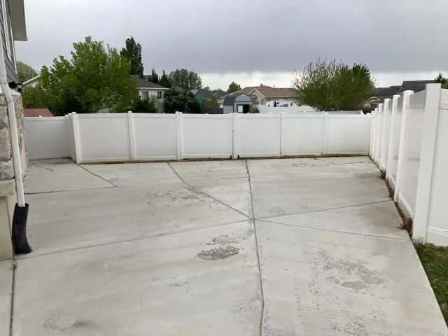 Fenced backyard with a patio area and a residential view