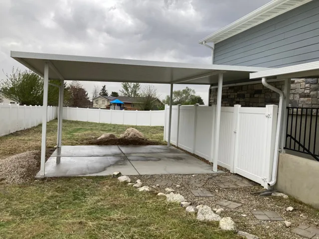 Fenced backyard featuring a gate and a patio area