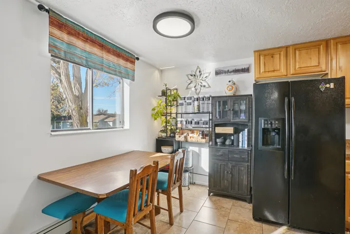 Dining area featuring a textured ceiling and light tile patterned flooring