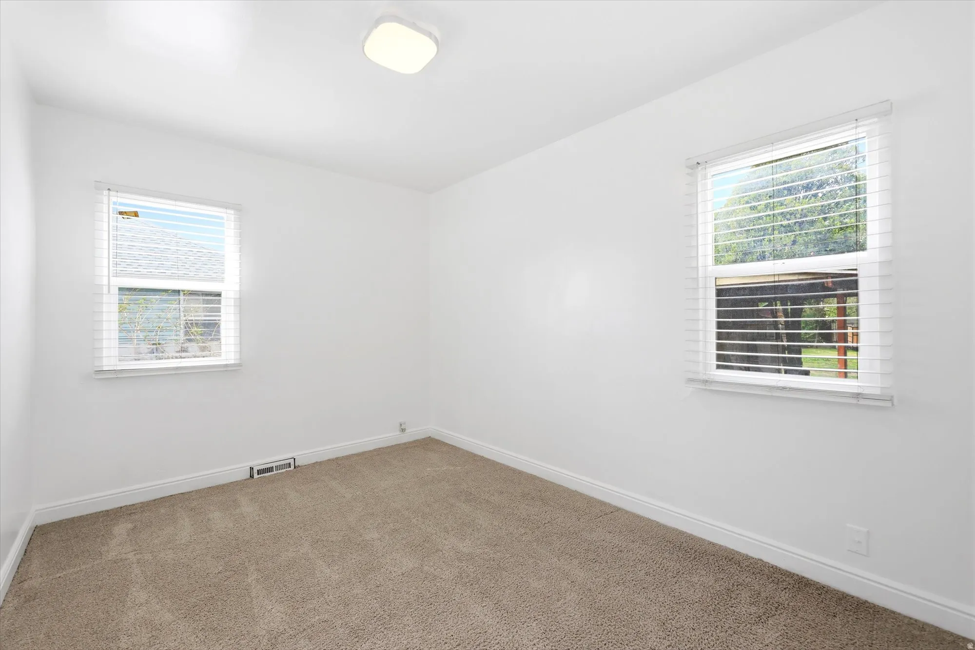 Carpeted empty room with baseboards