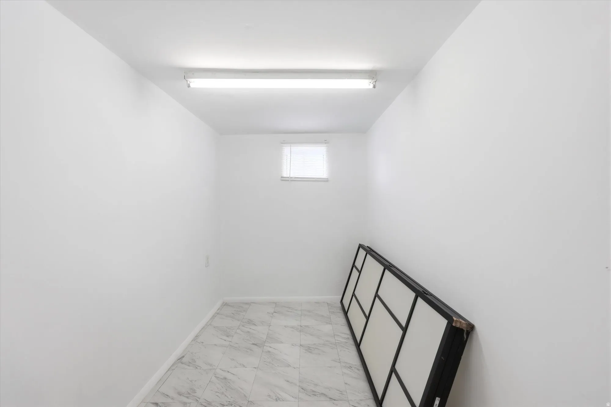 Empty room with light marble finish floors and baseboards