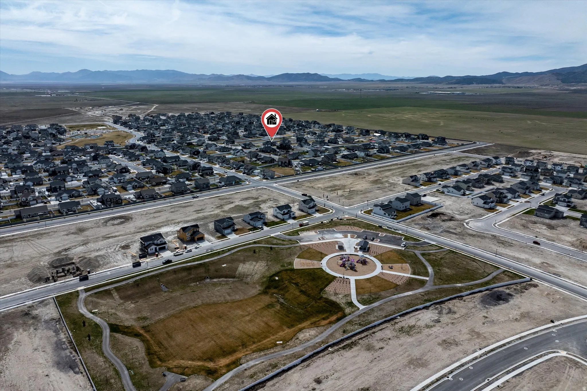 Aerial view of property's location featuring nearby suburban area and a mountain backdrop