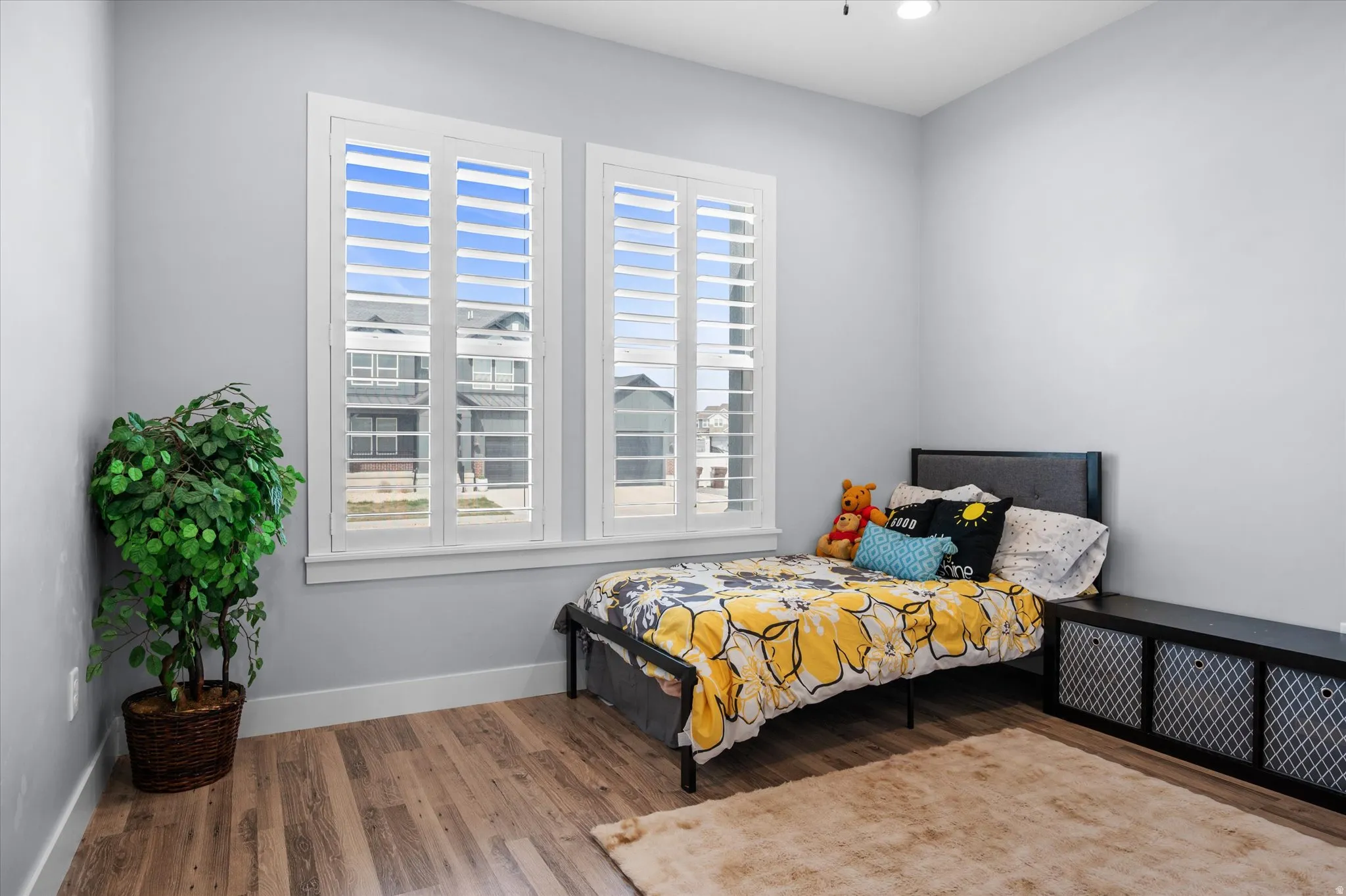 Bedroom featuring wood finished floors and baseboards