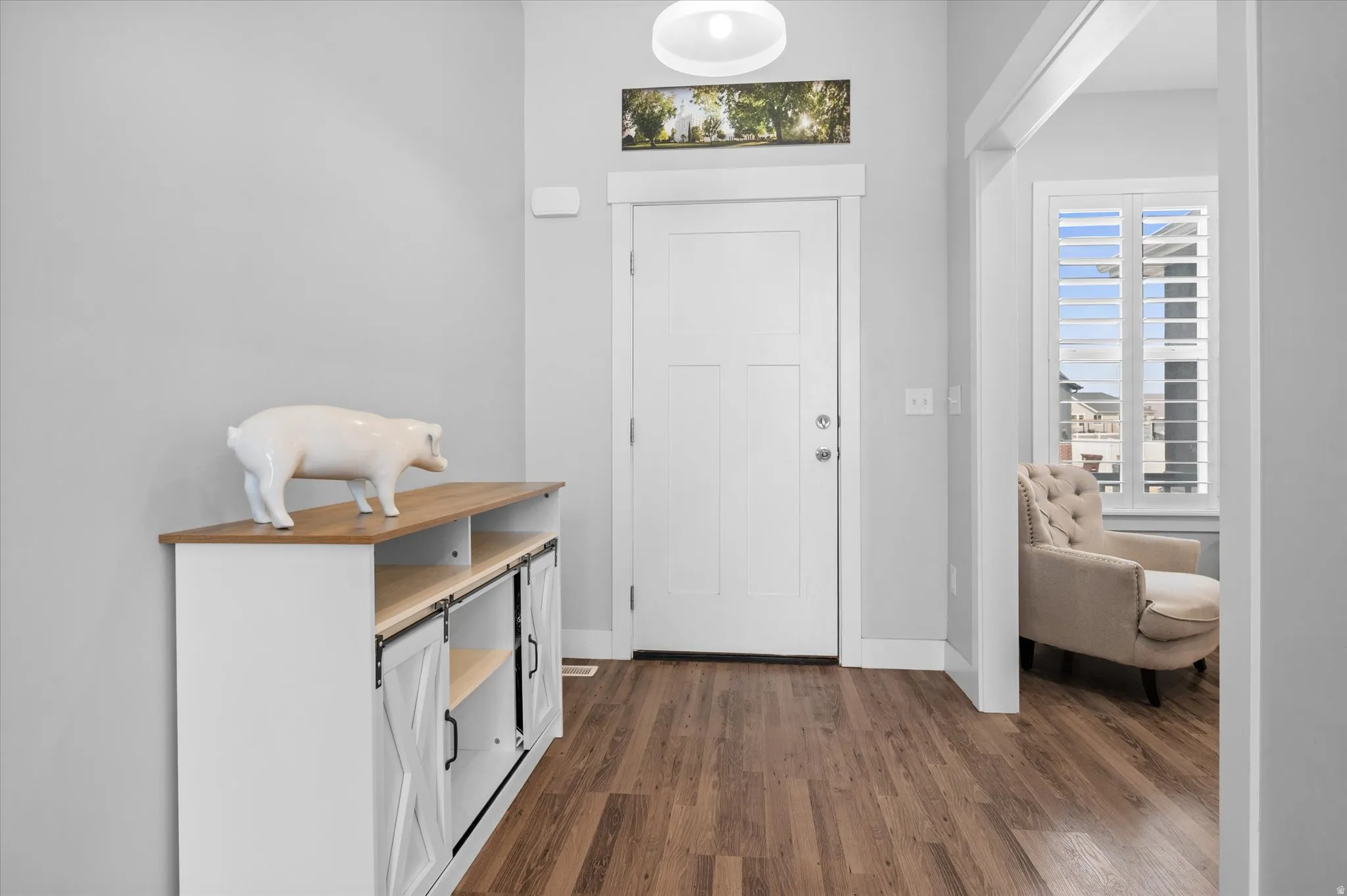 Entryway featuring dark wood-style floors and baseboards