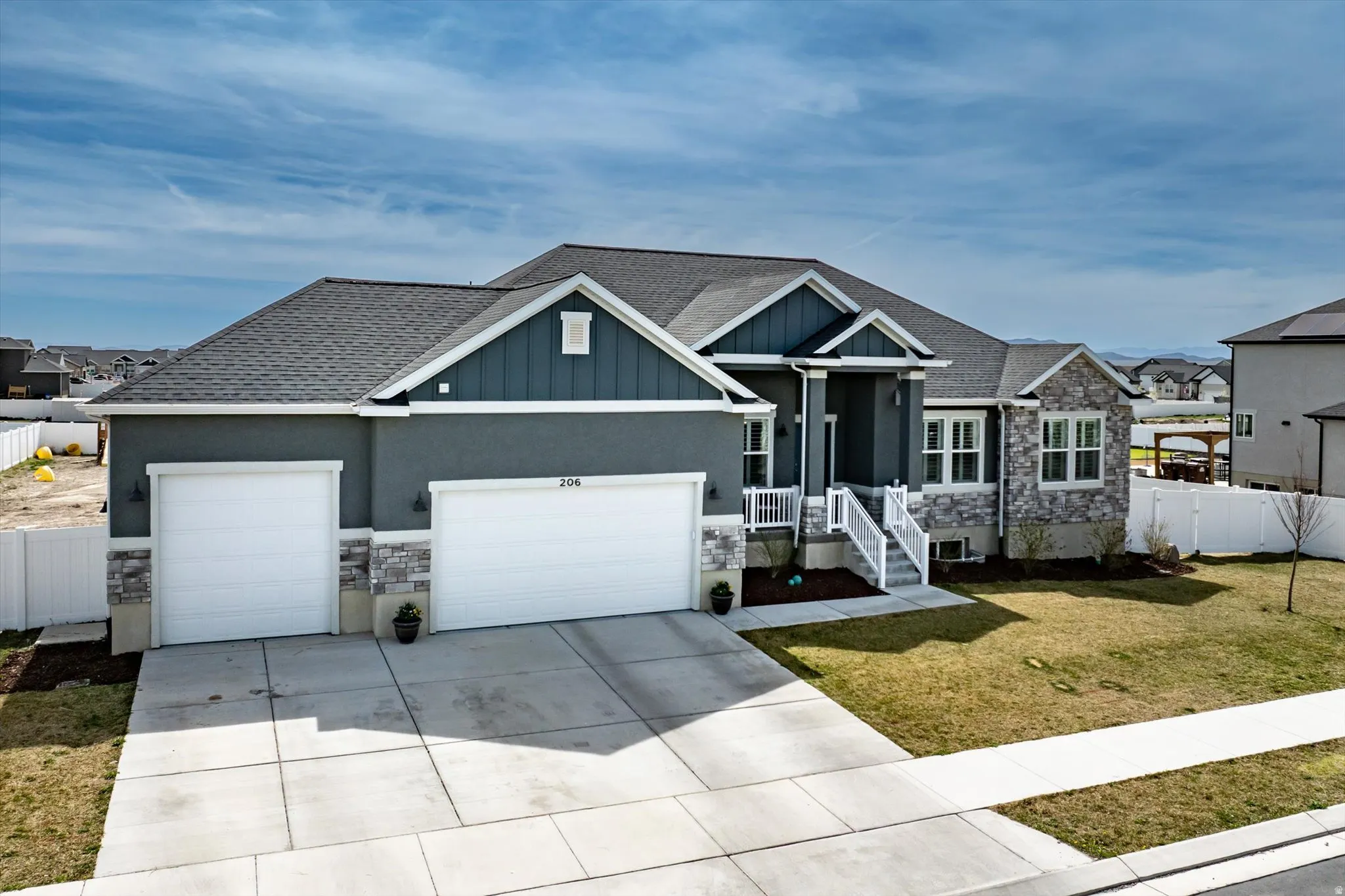Craftsman house with stone siding, a garage, roof with shingles, and concrete driveway