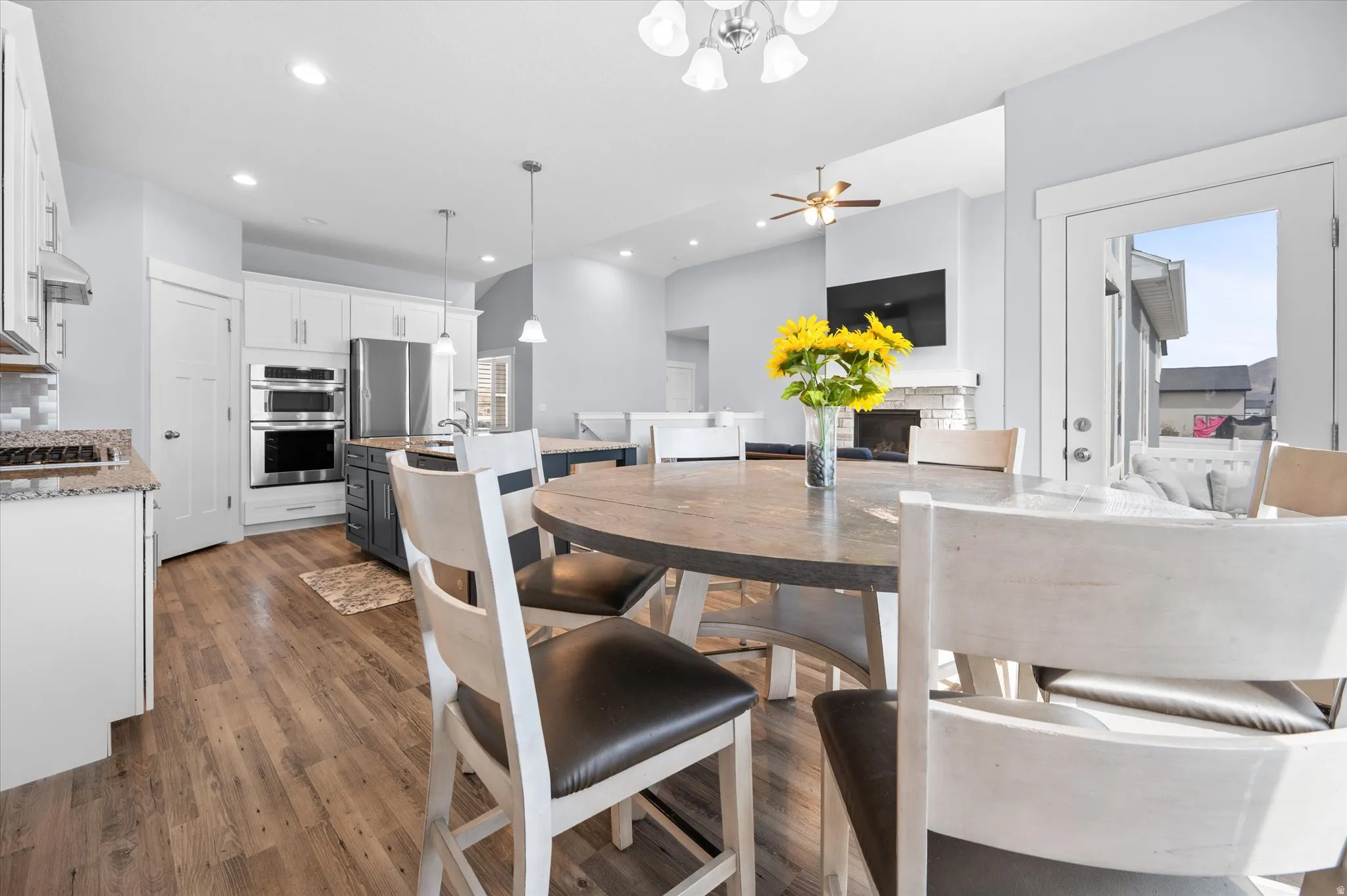 Dining room with ceiling fan, dark wood-style floors, and recessed lighting