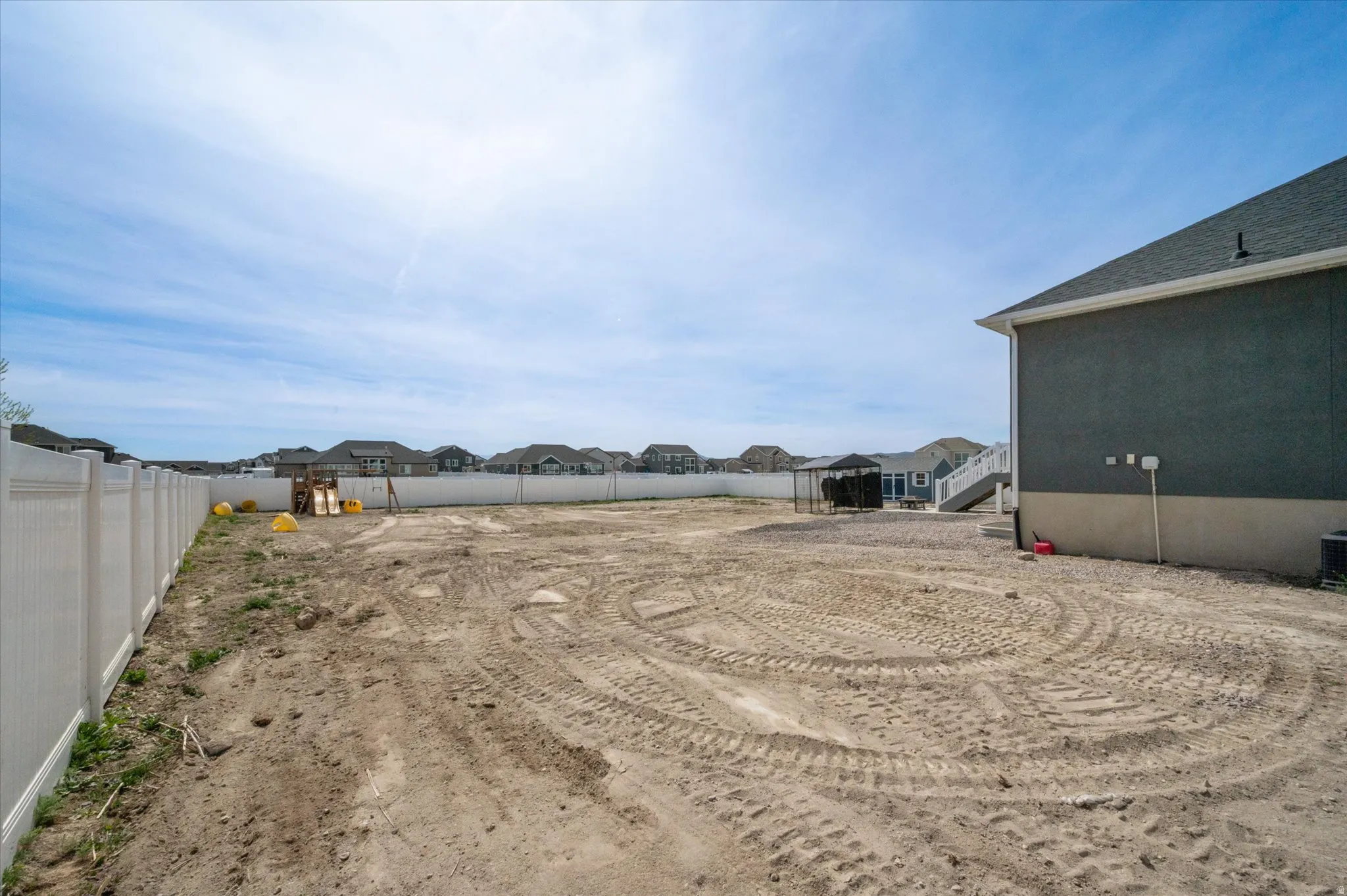 Fenced yard featuring a residential view. Side yard next to garage.