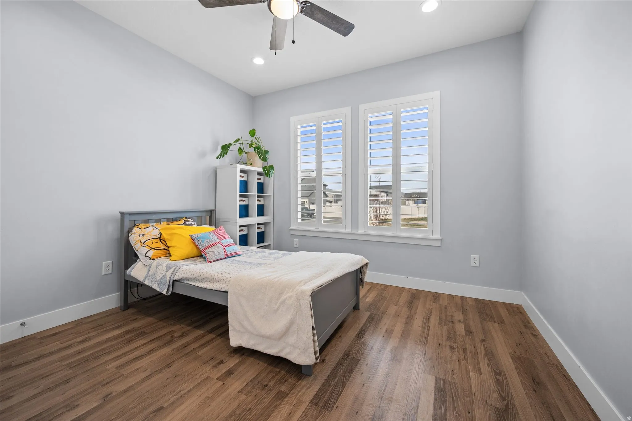 Bedroom with dark wood finished floors, a ceiling fan, and recessed lighting