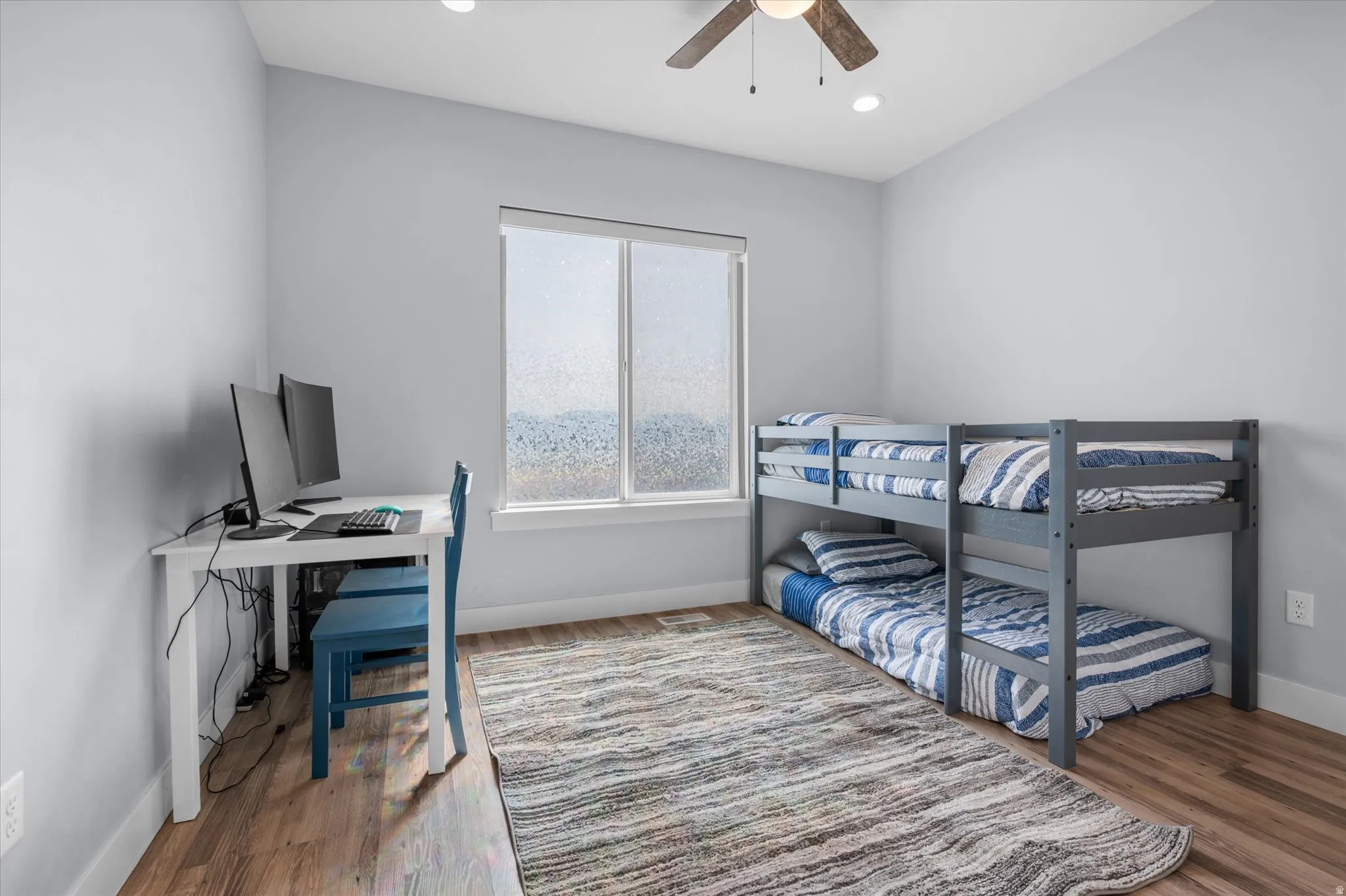 Bedroom with light wood finished floors, an office area, a ceiling fan, and recessed lighting
