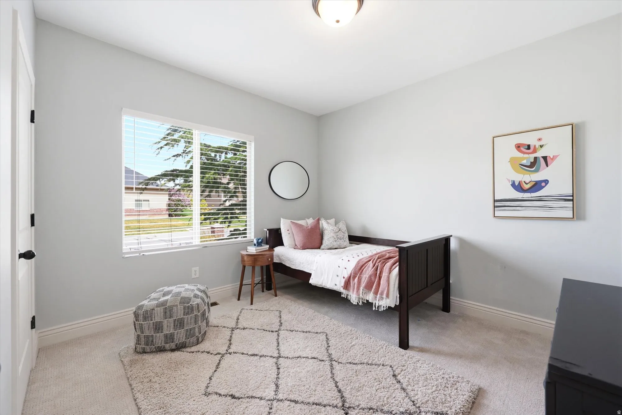Bedroom with light colored carpet