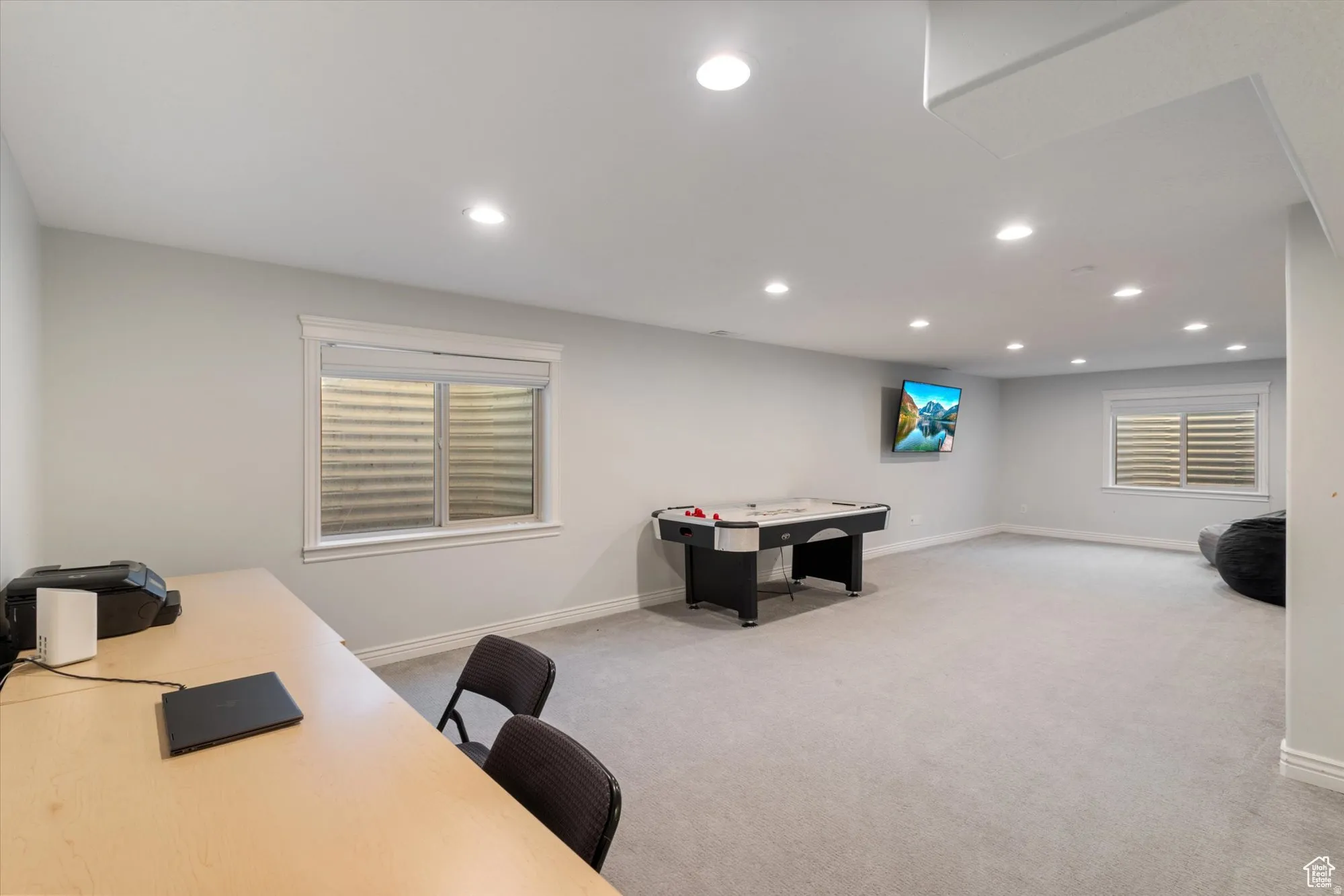 Home office with recessed lighting, light colored carpet, and plenty of natural light