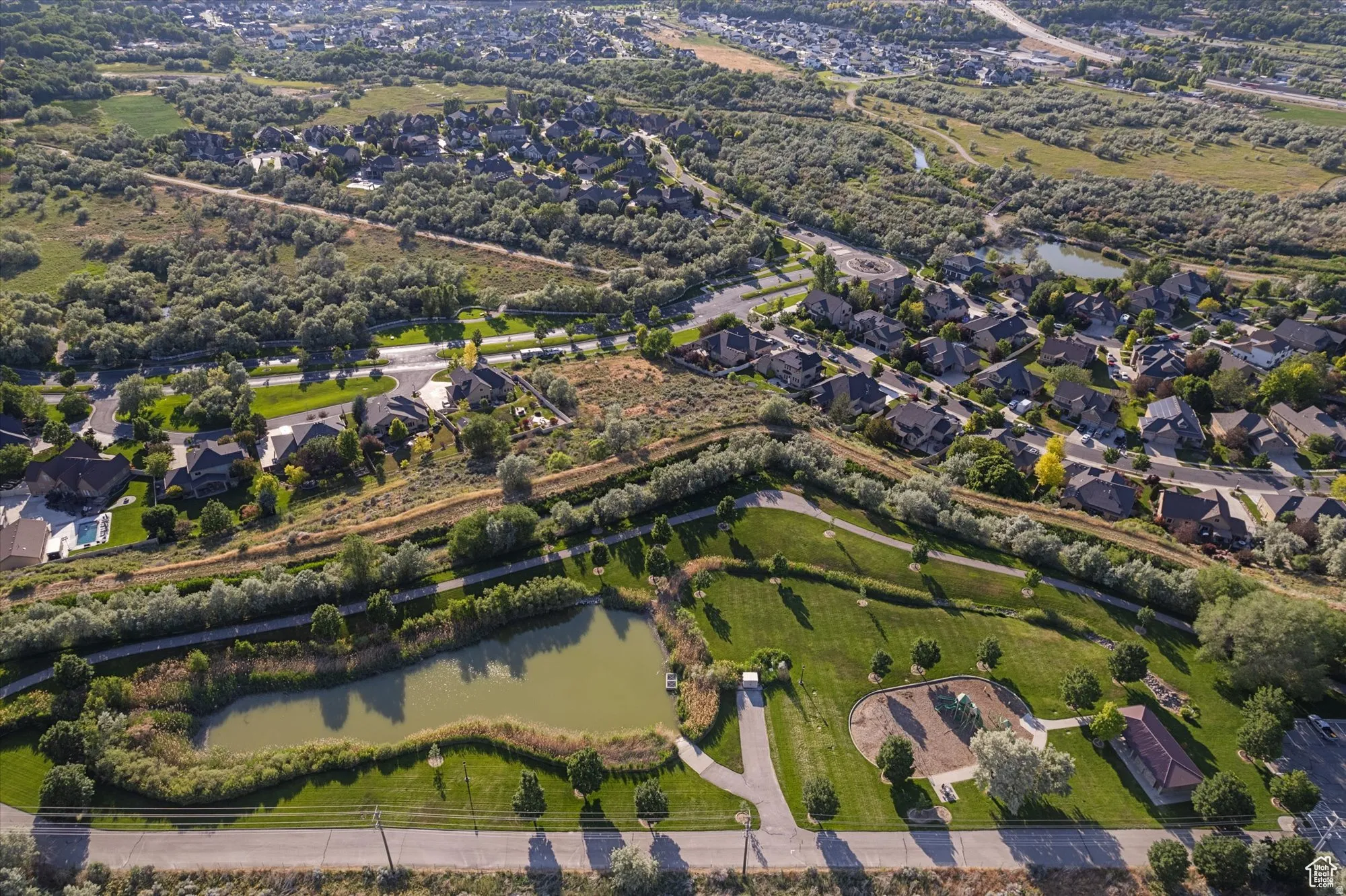 Aerial view of property's location with nearby suburban area and a nearby body of water