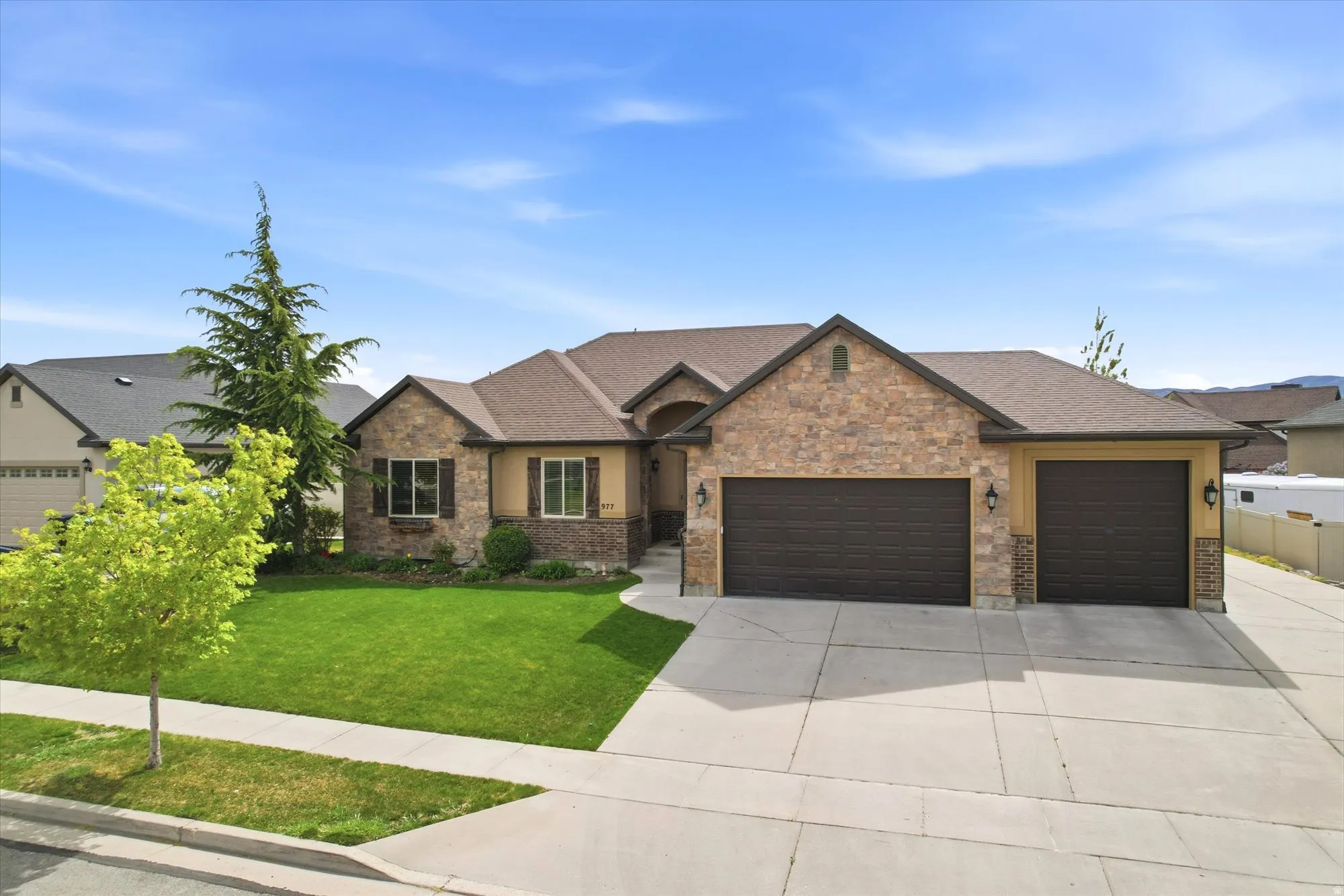 Craftsman-style house featuring a garage, a front lawn, concrete driveway, and a shingled roof