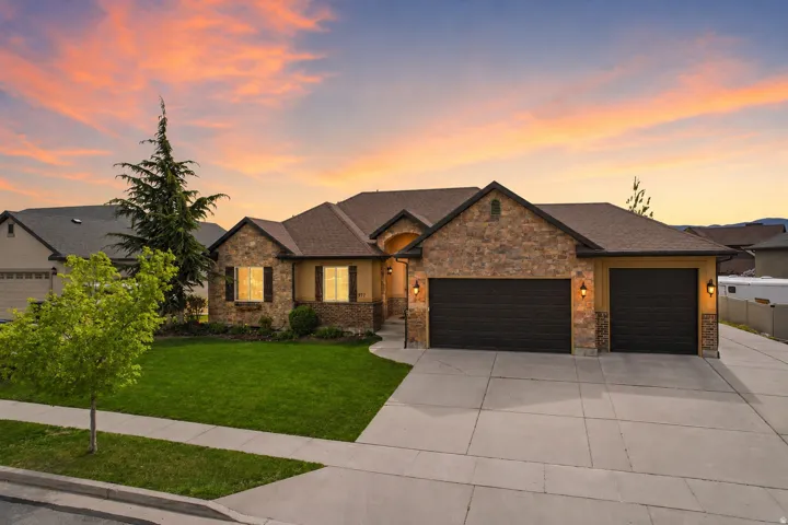 Stone veneer and stucco exterior with multiple gables