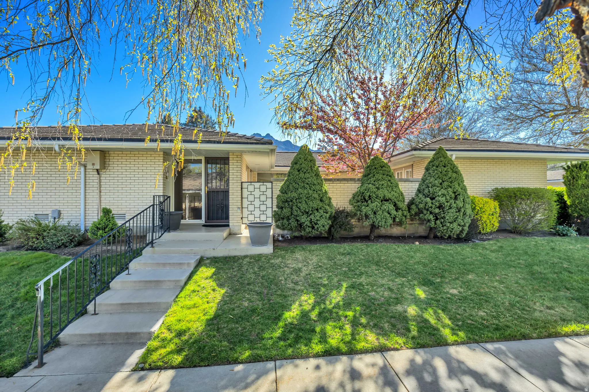 View of front of house with a front lawn and brick siding
