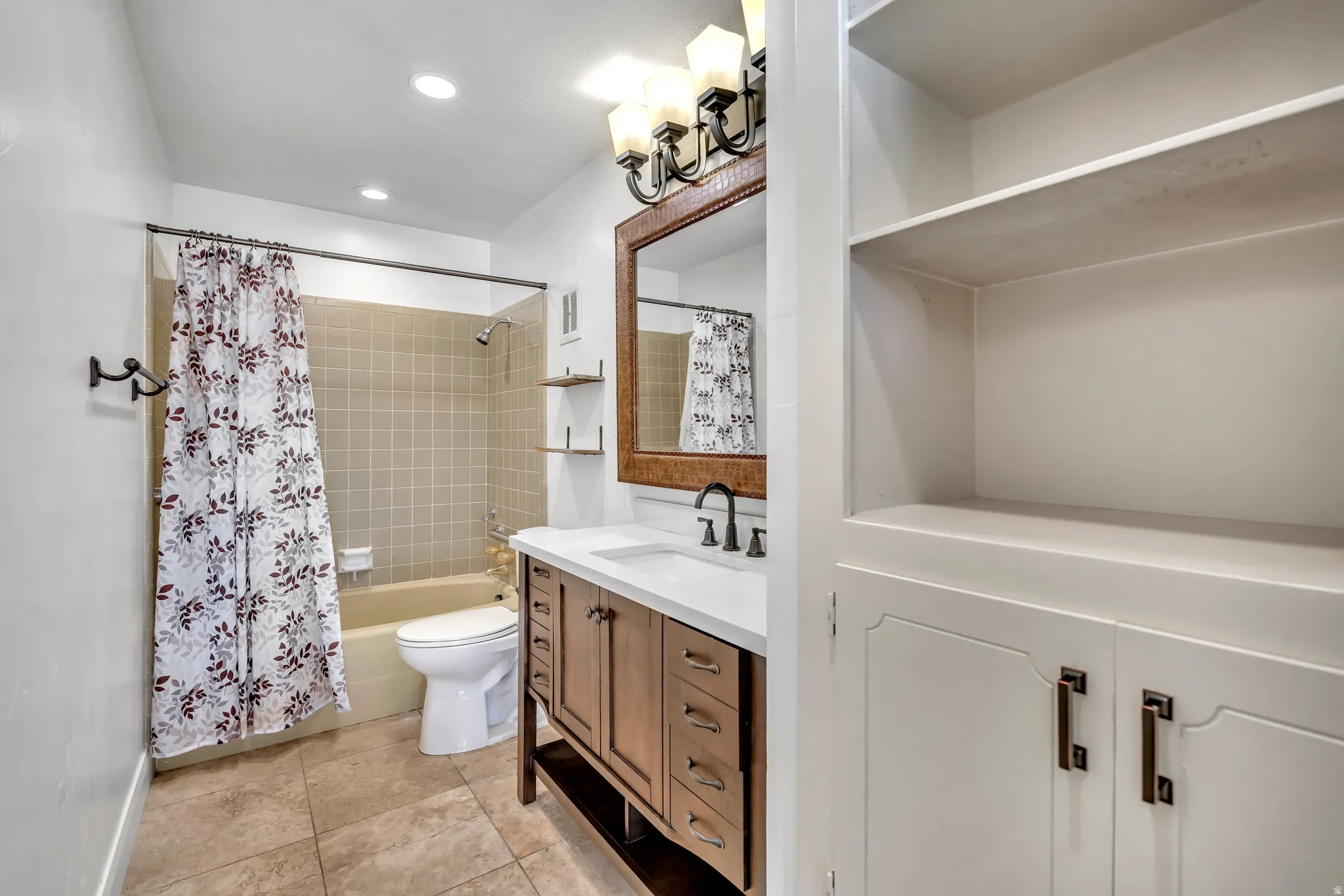 Full bath featuring vanity, shower / bath combo with shower curtain, light tile patterned flooring, and recessed lighting