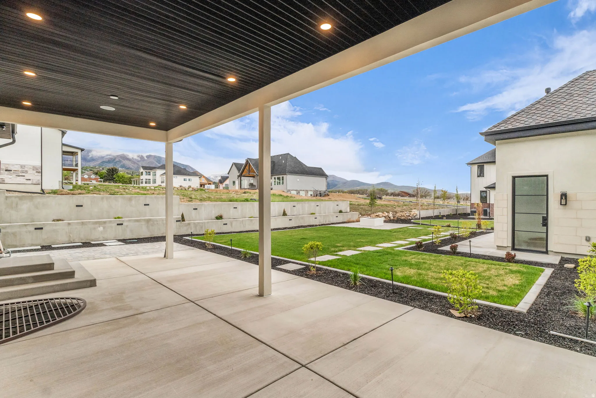 Fenced backyard with a mountain view, a patio area, and a residential view