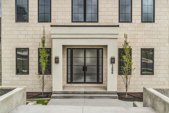 View of exterior entry with stucco siding