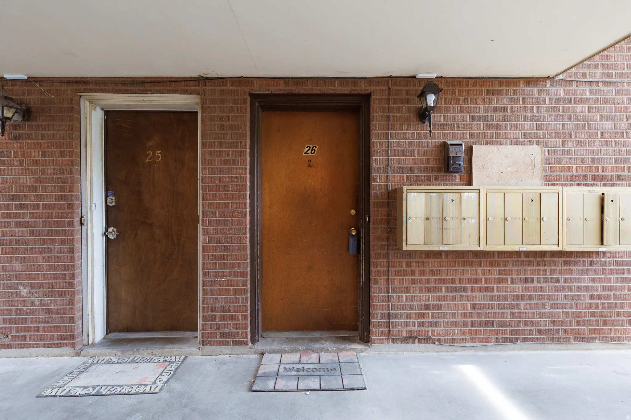 Doorway to property featuring brick siding