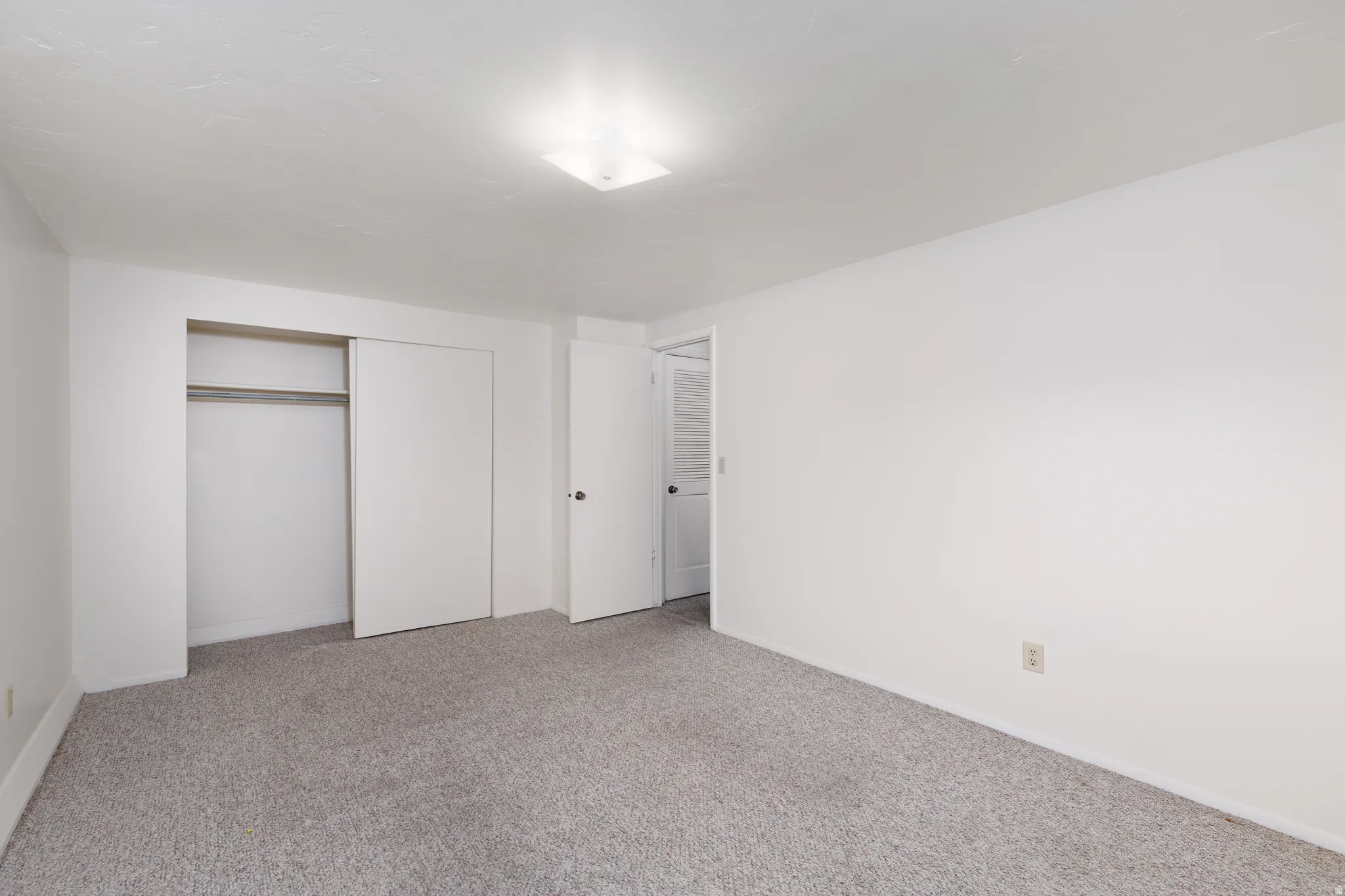 Unfurnished bedroom with a closet and carpet floors