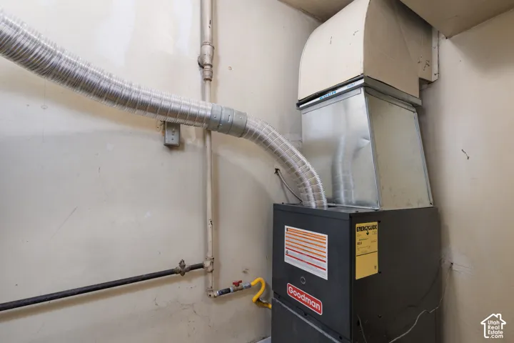 Utility room featuring heating unit