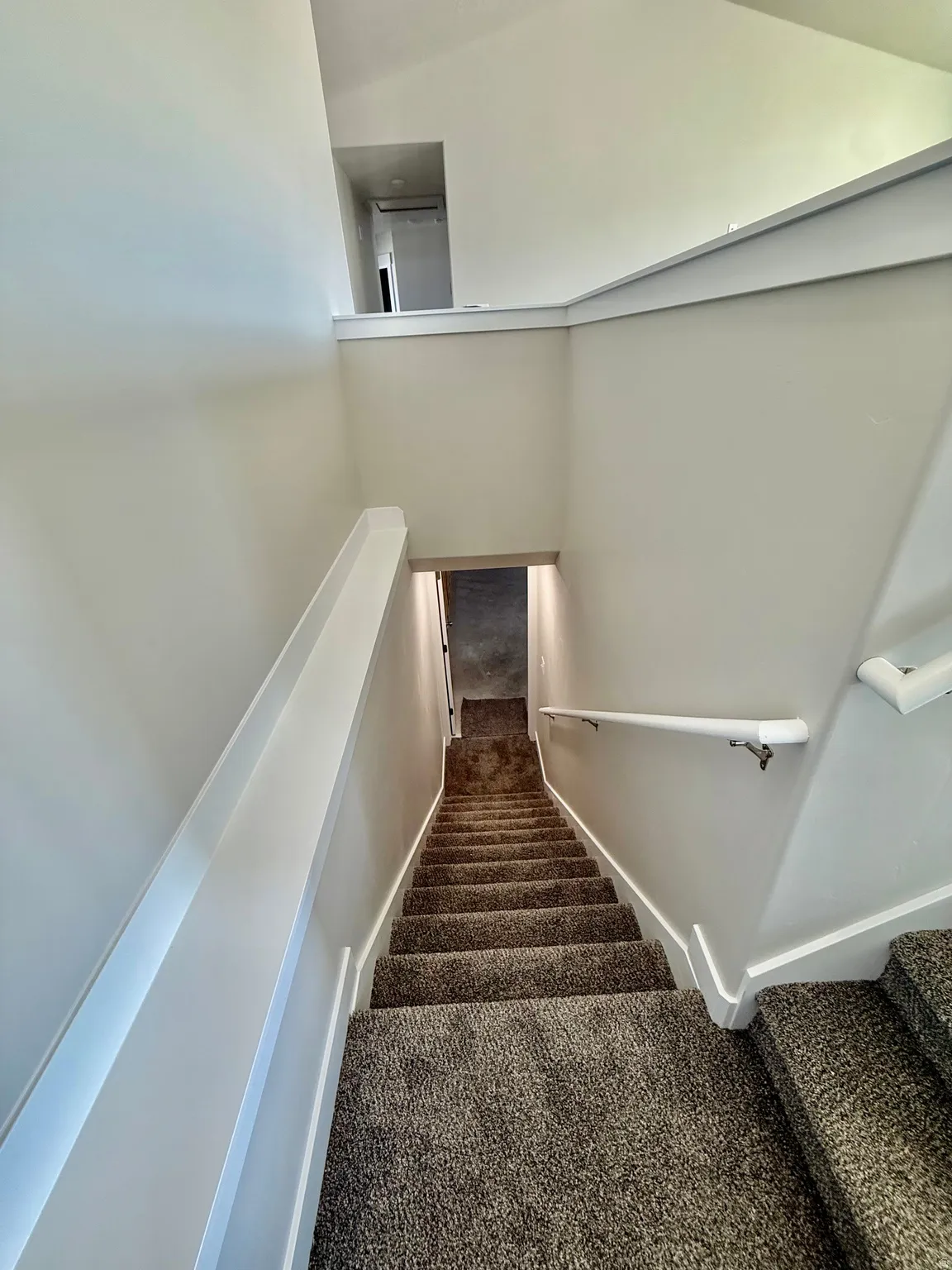 Stairs with carpet flooring and baseboards