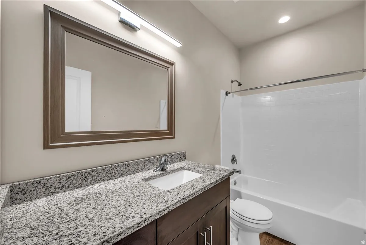 Bathroom featuring vanity, shower / washtub combination, and recessed lighting