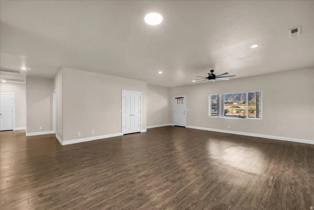 Spare room featuring dark wood finished floors, recessed lighting, and ceiling fan