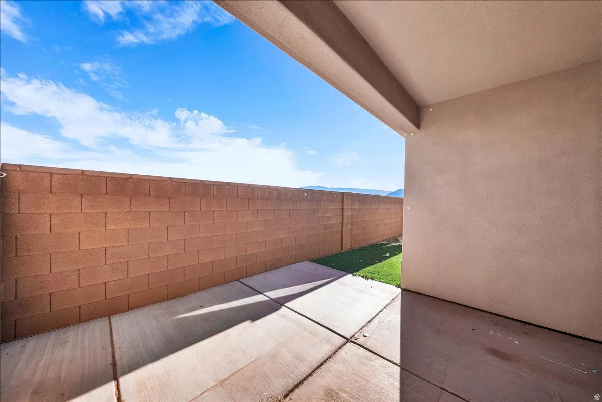 Fenced backyard with a patio